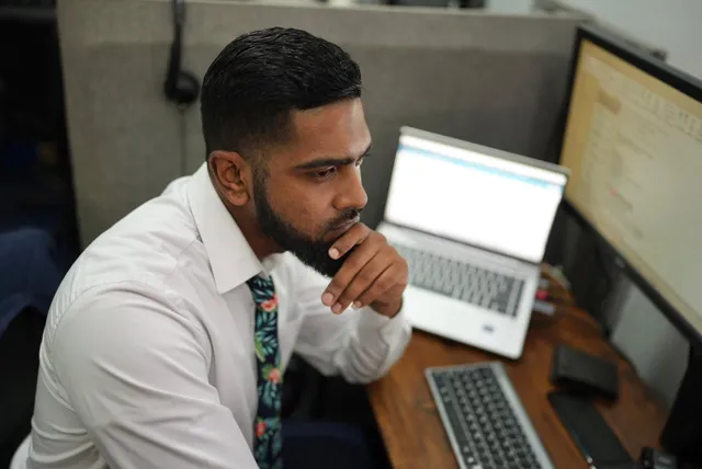 OSS staff member working at a laptop in the Georgetown, Guyana office