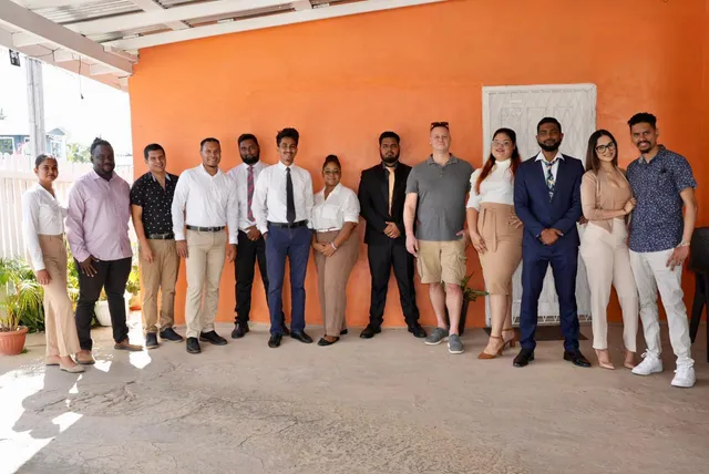 OSS staffing team of 13 employees outside their Georgetown, Guyana office